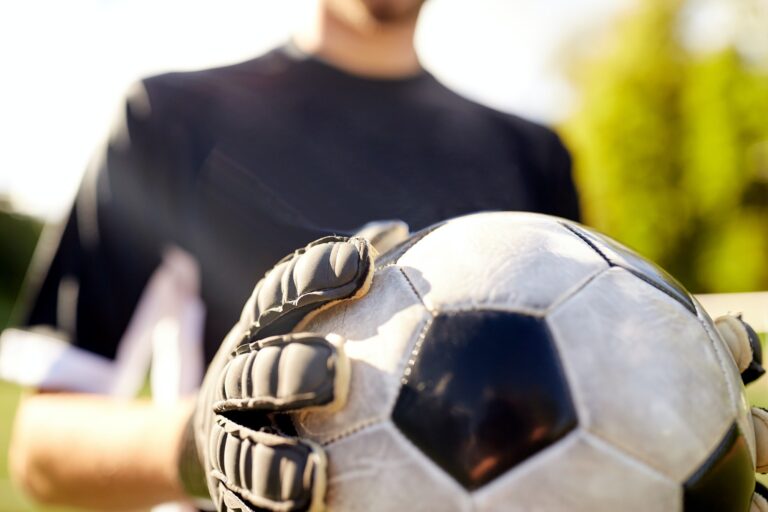 close up of goalkeeper with ball playing football